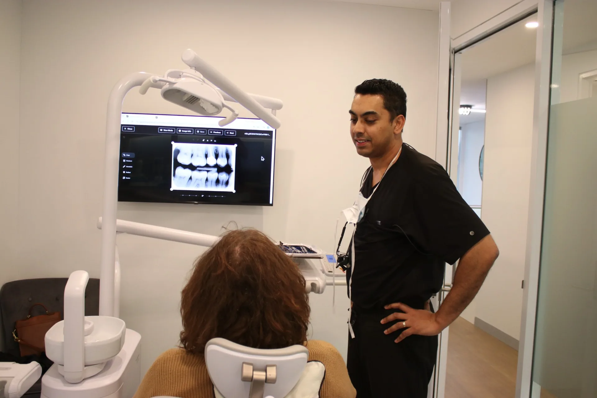 Dr Abhishek explaining an X-ray to a patient